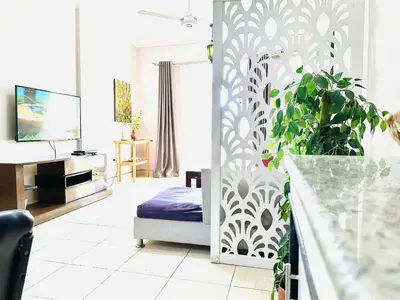 a living room with a couch and a tv at RITA HOUSE SEA VIEW. Hurghada center in Hurghada