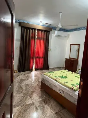 a bedroom with a bed and a red curtain at Valley Of The Kings House in Luxor