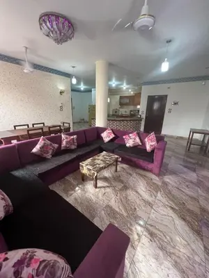 a living room with a purple couch and a table at Valley Of The Kings House in Luxor