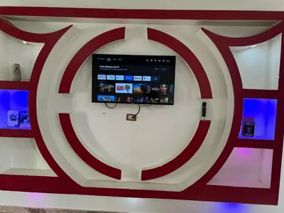 a tv on a wall with a red and white shield at Valley Of The Kings House in Luxor