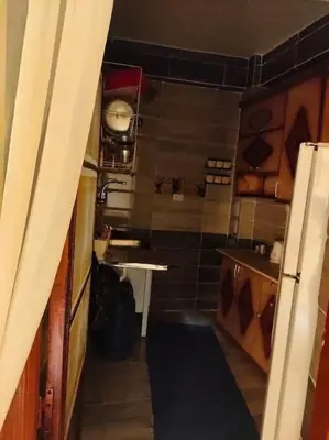 a small kitchen with a sink and a refrigerator at Nefertari Guest House in Aswan