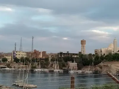 a view of a river with boats in a city at Nefertari Guest House in Aswan