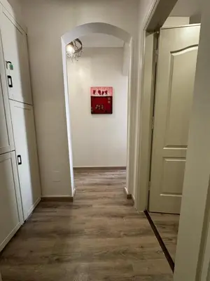an empty hallway with a door and a painting on the wall at Apartment with private Beach in Sahl Hasheesh in Hurghada