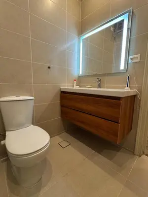 a bathroom with a toilet and a sink and a mirror at Apartment with private Beach in Sahl Hasheesh in Hurghada