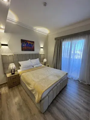 a large bedroom with a large bed with two lamps at Apartment with private Beach in Sahl Hasheesh in Hurghada