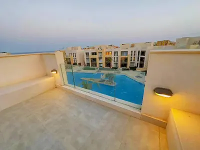 an apartment balcony with a view of a swimming pool at Mangrovy 2 BR Gouna in Hurghada