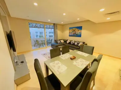 a living room with a table and a couch at Mangrovy 2 BR Gouna in Hurghada