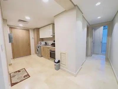 a large kitchen with white walls and a counter top at Mangrovy 2 BR Gouna in Hurghada
