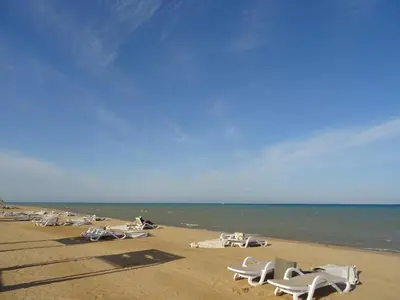 a group of chairs on a beach near the water at Mangrovy 2 BR Gouna in Hurghada