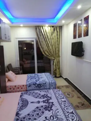a bedroom with two beds and a blue ceiling at Cecelia Resort in Hurghada