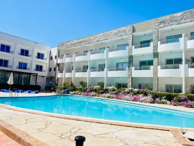 a swimming pool in front of a building at Cecelia Resort in Hurghada