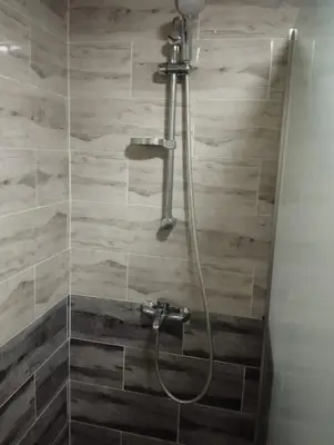 a shower in a bathroom with wooden tiles at Cecelia Resort in Hurghada