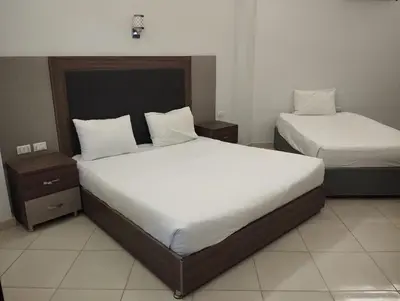 a bedroom with two beds and two night stands at Cecelia Resort in Hurghada