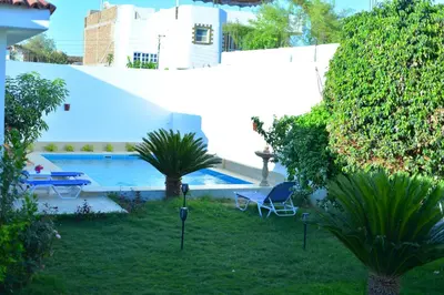 a yard with a swimming pool and a house at Luxor Rose Villa in Luxor