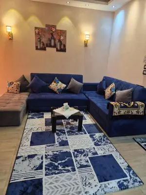 a living room with a blue couch and a table at STAR HOME HURGHADA ARABIA in Hurghada