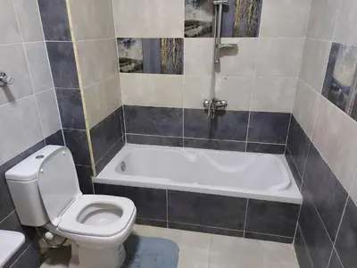 a bathroom with a toilet and a bath tub at STAR HOME HURGHADA ARABIA in Hurghada