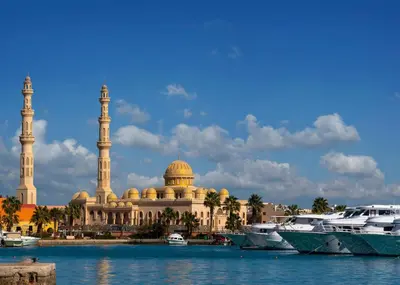 a large building with two domes and boats in the water at STAR HOME HURGHADA ARABIA in Hurghada