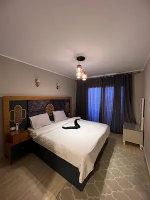 a bedroom with a large bed with a black cat on it at Villa KUBA luxury private pool Hurghada in Hurghada