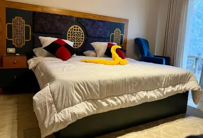 a bedroom with a bed with a yellow duck on it at Villa KUBA luxury private pool Hurghada in Hurghada