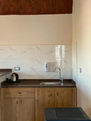 a kitchen with a sink and a counter top at Tasneem Palace in Luxor