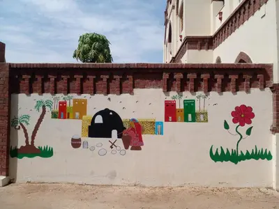 a wall with a mural of a woman and a tree at Tasneem Palace in Luxor