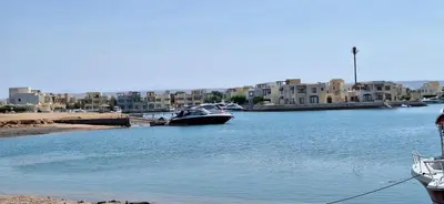 a boat is docked in a harbor with buildings at El Gouna Fanadir Lagoon 2-Bedroom Pool and Lagoon View Sleeps 4 Persons, Close to Abu Tig Marina, Mangroovy, and Kite Centers in El Gouna
