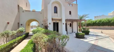 a large white church with a courtyard with trees at El Gouna Fanadir Lagoon 2-Bedroom Pool and Lagoon View Sleeps 4 Persons, Close to Abu Tig Marina, Mangroovy, and Kite Centers in El Gouna