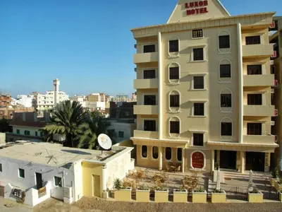 a building with a clock on the top of it at Luxor Hotel Hurghada in Hurghada