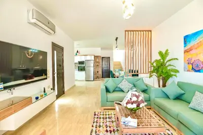 a living room with a blue couch and a table at Hurghada Sahl Hasheesh sea-view Villa with private pool in Hurghada