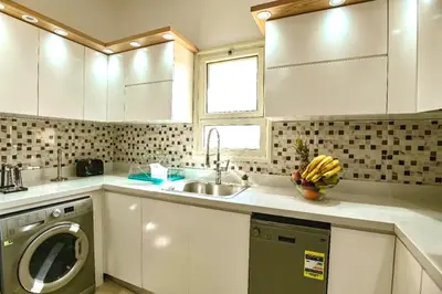 a kitchen with a sink and a washing machine at Hurghada Sahl Hasheesh sea-view Villa with private pool in Hurghada