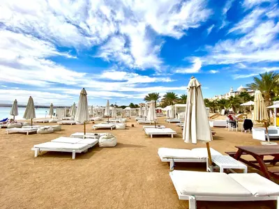 a beach with white lounge chairs and umbrellas at Hurghada Sahl Hasheesh sea-view Villa with private pool in Hurghada