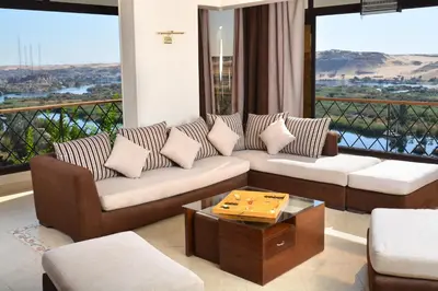 a living room with two couches and a table at ASWAN NILE PALACE (swimming pool-rooftop-Nile view) in Aswan