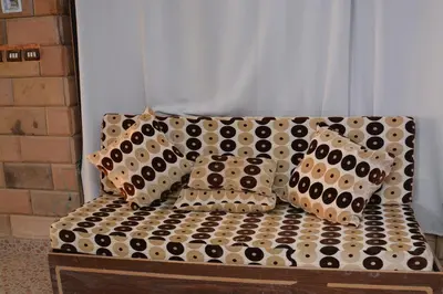 a couch with black and white pillows on it at ASWAN NILE PALACE (swimming pool-rooftop-Nile view) in Aswan