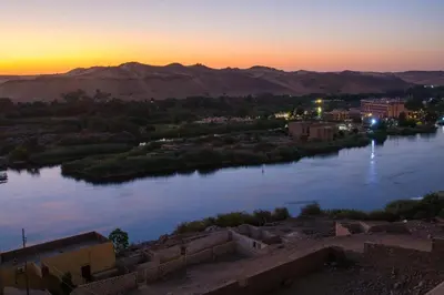 a view of a river with a city and mountains at ASWAN NILE PALACE (swimming pool-rooftop-Nile view) in Aswan