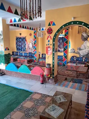 a room with an archway in a room with colorful items at Lawanda Nubian B&B in Aswan