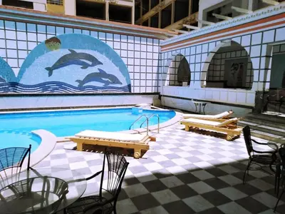 a swimming pool with a mural of dolphins on the wall at Studio pool view next to the Marina,Sheraton Plaza 320 in Hurghada