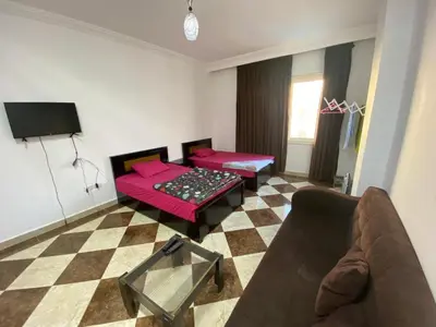 a living room with a couch and a table at Studio pool view next to the Marina,Sheraton Plaza 320 in Hurghada
