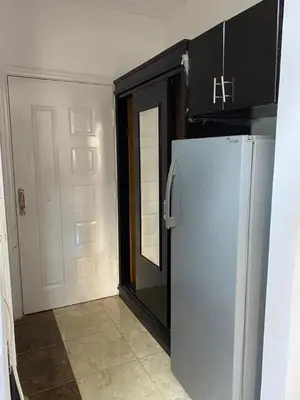 a kitchen with a refrigerator next to a door at Studio pool view next to the Marina,Sheraton Plaza 320 in Hurghada
