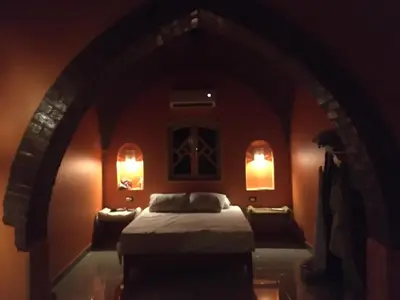 a bedroom with a bed and two lights on the wall at Golden palace Nile view - Appartment in Luxor