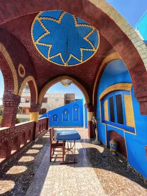 a blue building with a blue table in the middle at Golden palace Nile view - Appartment in Luxor