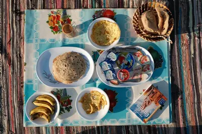 a table with plates of food on a tray at My Dream Nile Felucca in Aswan