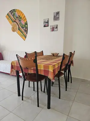 a dining room table and chairs with a table and a couch at Hurghada Village sea view in Hurghada