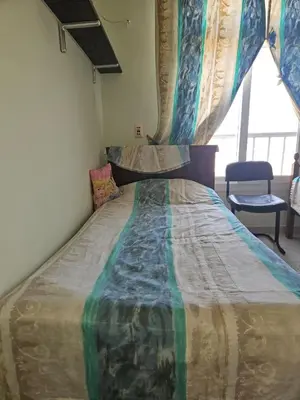 a large bed in a room with a window at Hurghada Village sea view in Hurghada