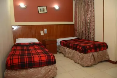 a hotel room with two beds in a room at New Saint Catherine Hotel in Luxor