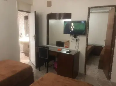 a room with a desk with a television and a mirror at New Saint Catherine Hotel in Luxor