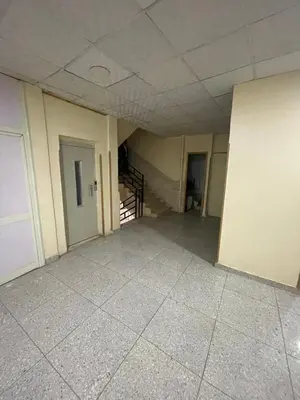 an empty room with a staircase in a building at Makkah Hotel in Qena