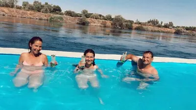 a group of people in a swimming pool in the water at Fenti Nubian Resort in Aswan