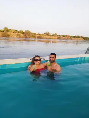 a man and a woman in a pool of water at Fenti Nubian Resort in Aswan