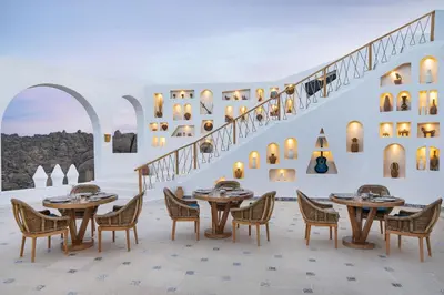 a restaurant with tables and chairs and a staircase at Benben by Dhara Hotels - Adults Only in Aswan
