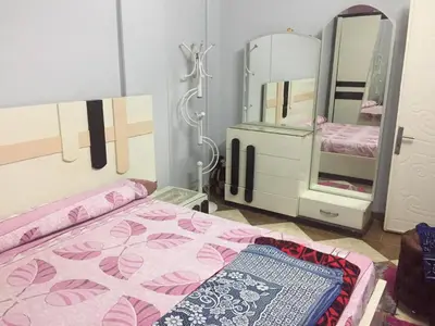 a bedroom with a bed and a mirror at Babylon guesthouse in Aswan